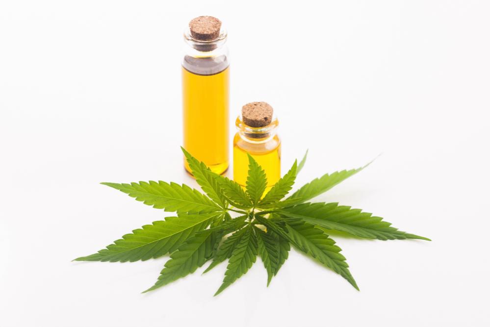 CBD oil bottles with marijuana leaves