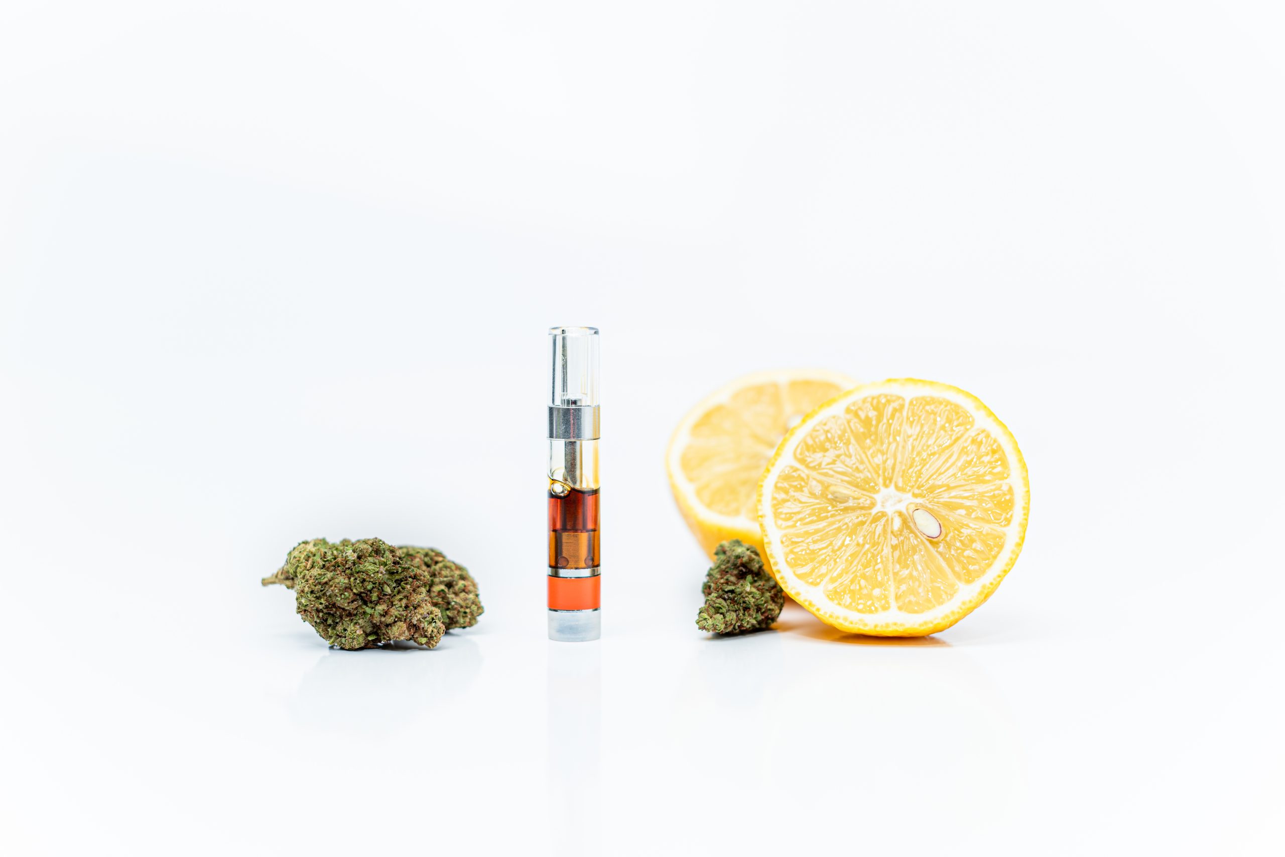 Cannabis vape cartridge and lemons. Limonene terpene concept.